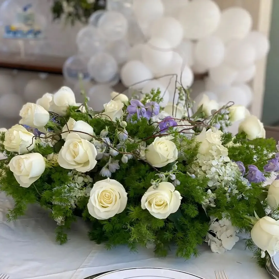 Detalle de rosas blancas y lavanda en un centro de mesa