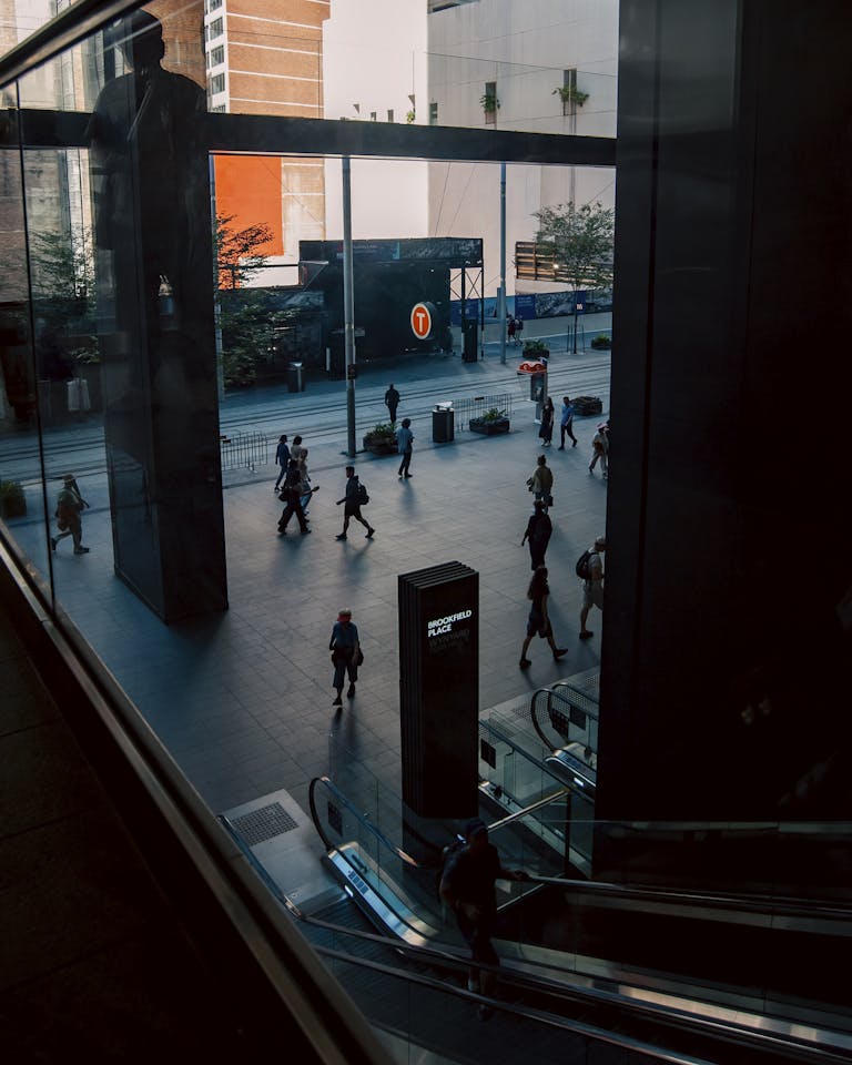 View of people commuting at Wynyard Station in Sydney with modern architecture.