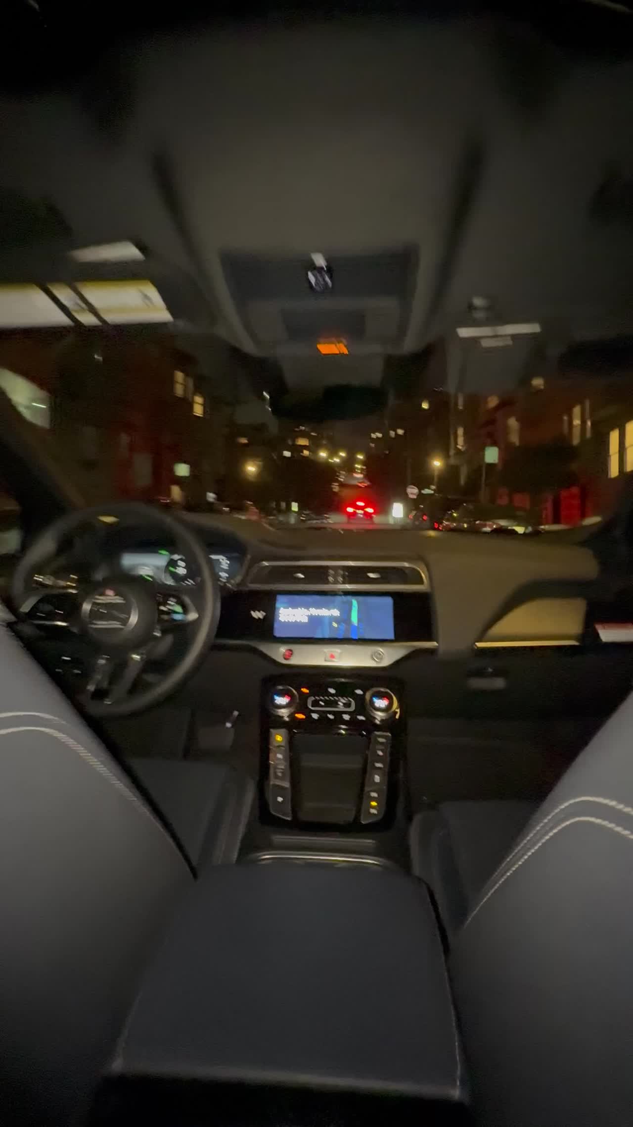 The Waymo's steering wheel turning by itself as the car drives through San Francisco at night
