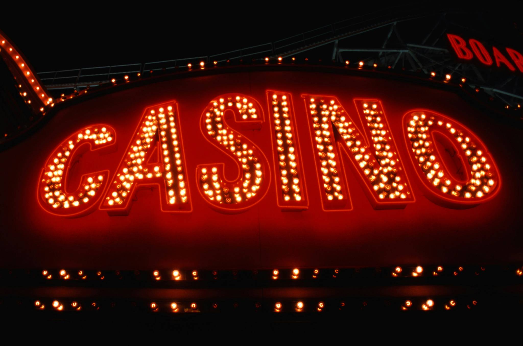 Illuminated casino sign in bright red with vintage light bulbs, suggesting a classic, lively nightlife atmosphere—an option for fun things to do with friends in Sydney, especially for those interested in the city's entertainment and gaming venues.