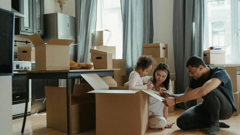 A couple packing boxes for an international move