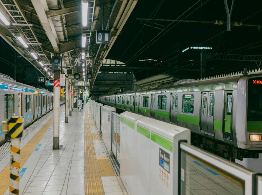 A traveller tapping an IC card at a Japanese station gate