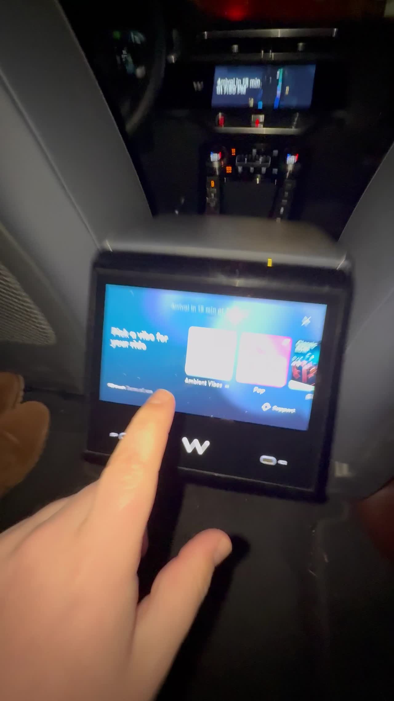 The Waymo rear passenger screen with the pick-a-vibe options for music