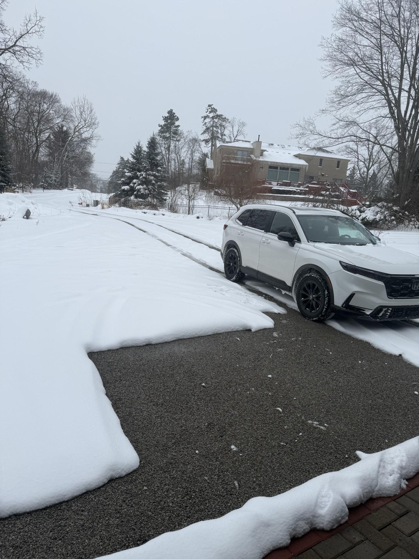 Clear dry driveway with snow melted away from heated surface in winter