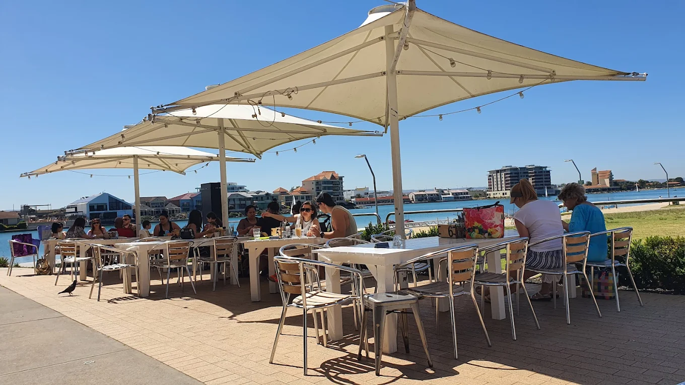 OAR outdoor lakeside dining with umbrellas and water views