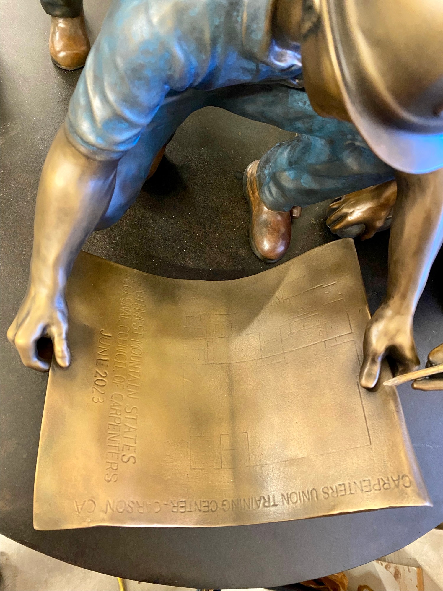 Bronze sculpture base detail with inscription
