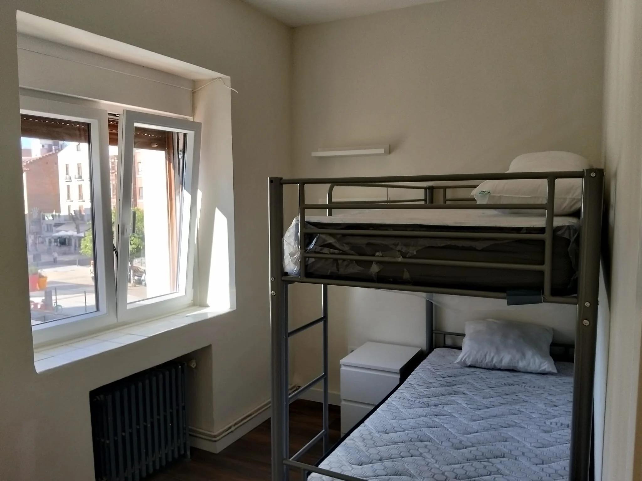 Habitación doble con litera junto a la ventana en el apartamento del Colegio Mayor San Juan Evangelista