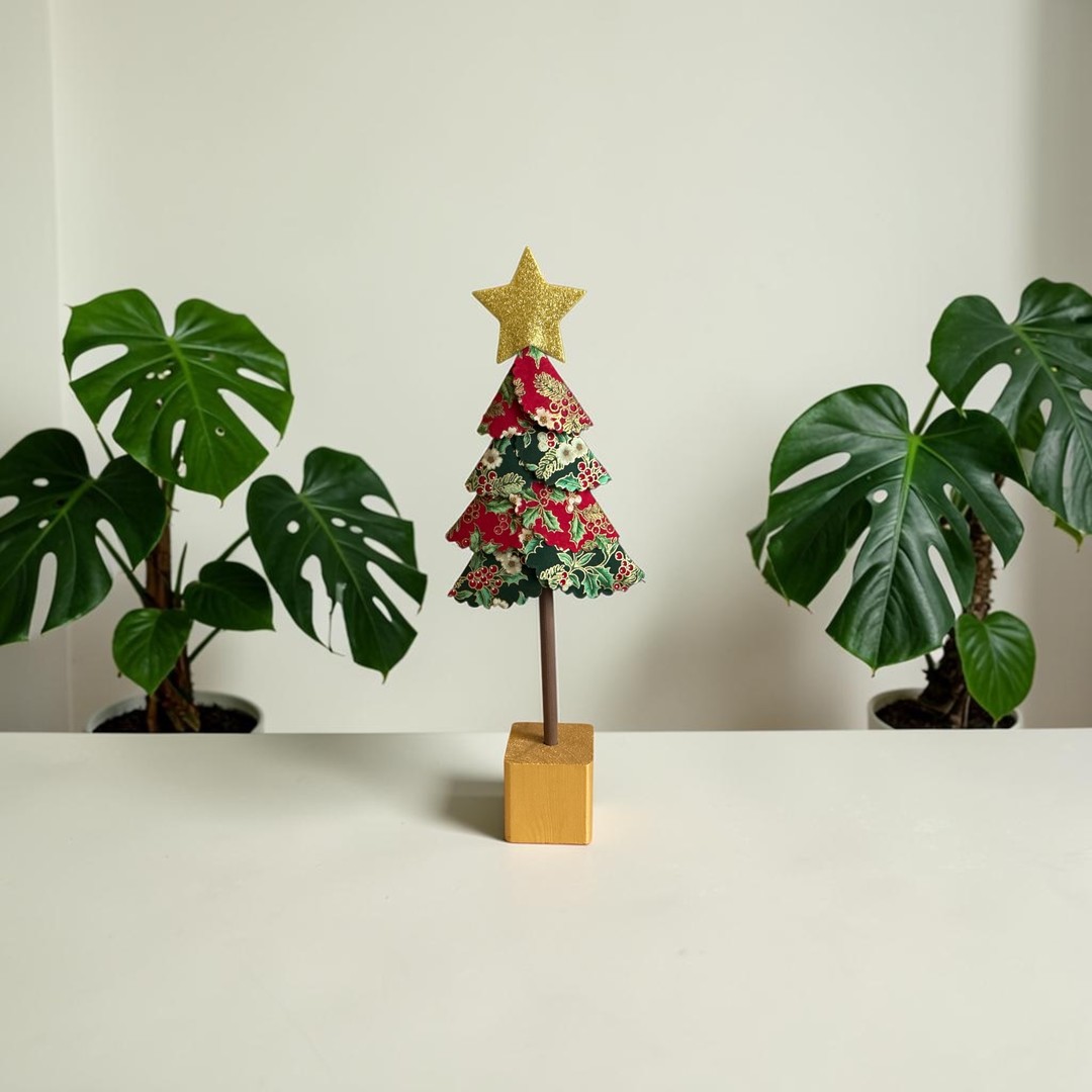 Large handmade fabric Christmas tree in holly and berry print on a gold wooden block
