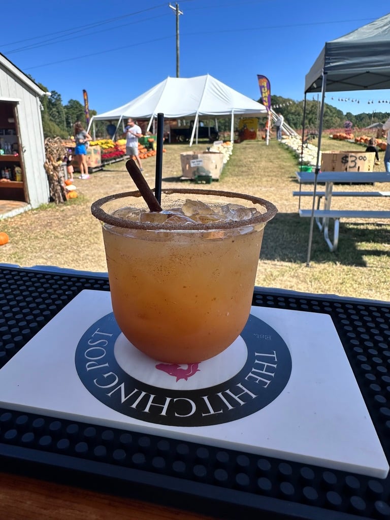 Craft drink on The Hitching Post branded bar mat at a fall gathering