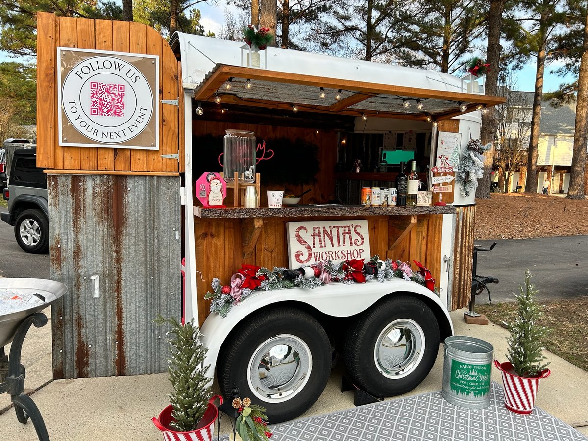 Holiday drink topped with whipped cream and a gingerbread man at The Hitching Post bar