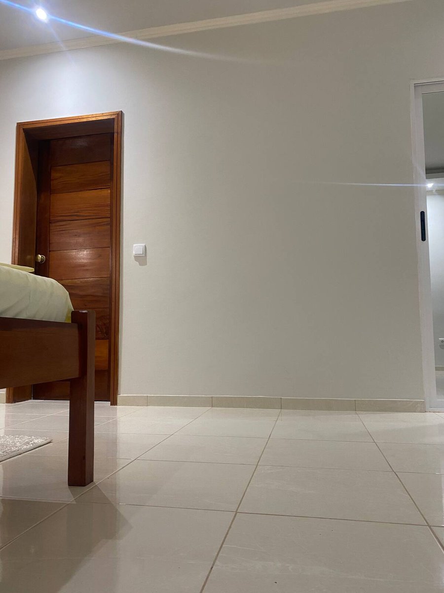 One-bedroom apartment bedroom with sliding glass door to the balcony at Residencial Bigasso