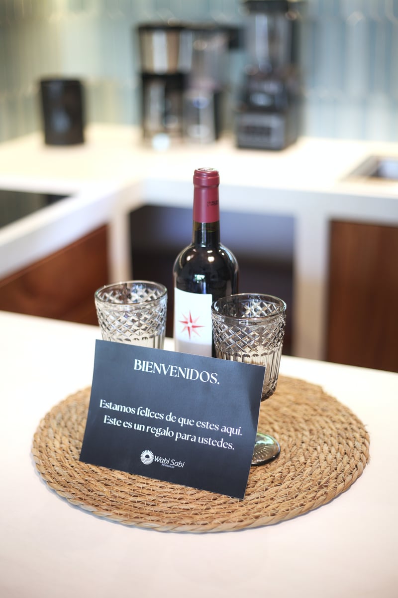 Bienvenidos welcome card with wine at Wabi Sabi Residences