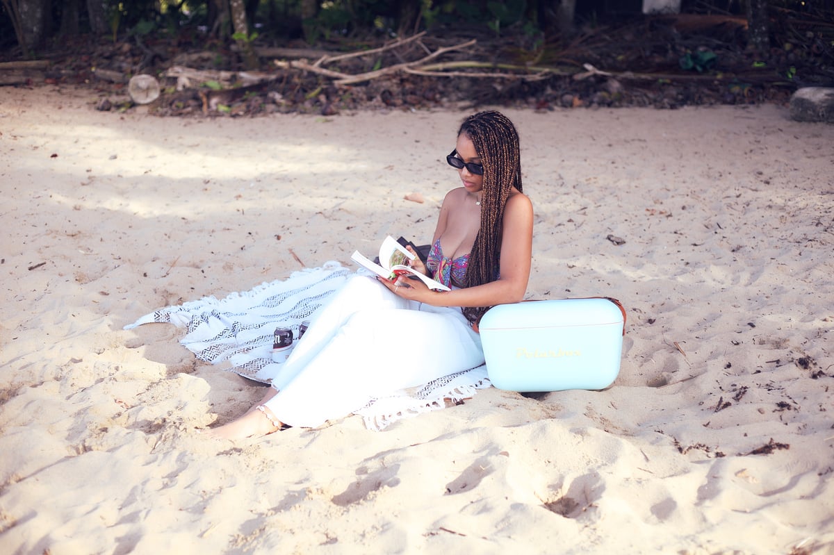 Woman reading on the beach near Wabi Sabi Residences, Punta Uva