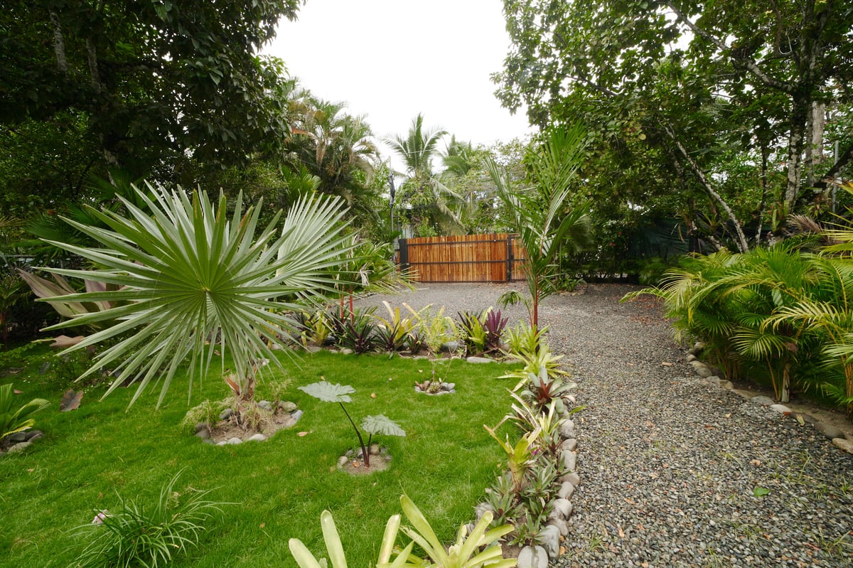 Lush tropical garden path at Wabi Sabi Residences, Punta Uva
