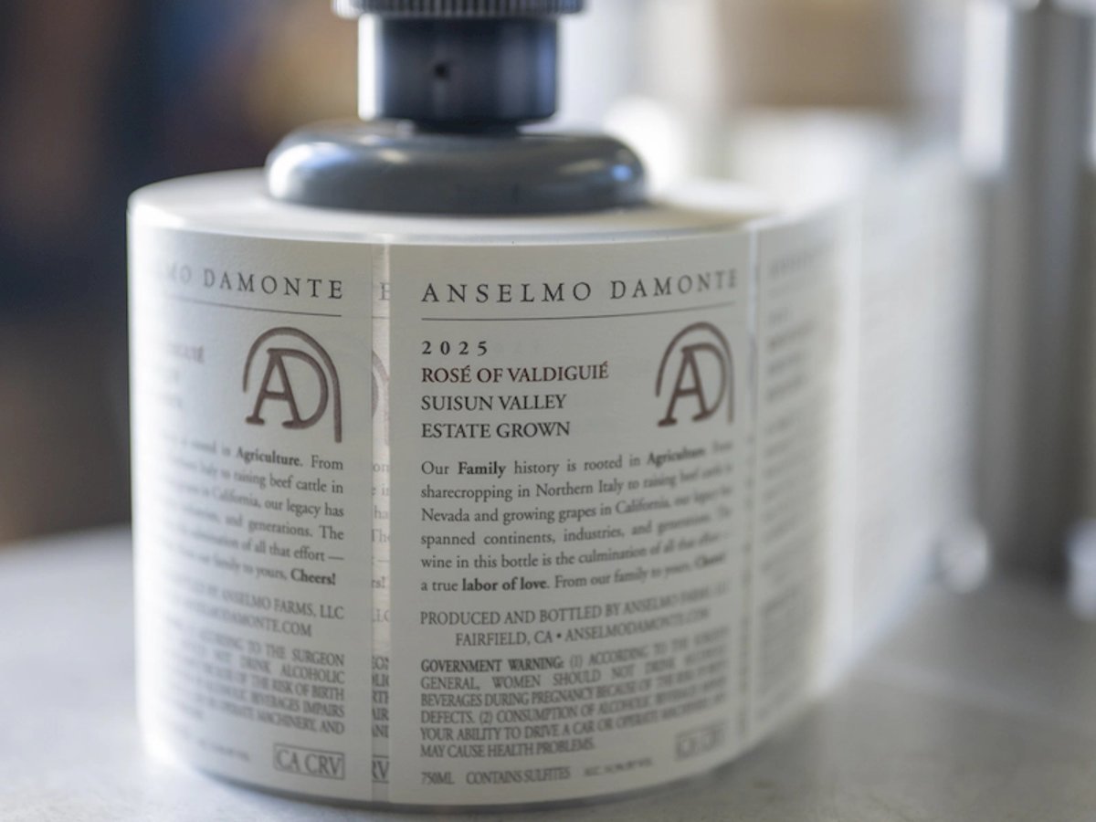 Anselmo Damonte Rosé of Valdiguié wine label being applied at the bottling line