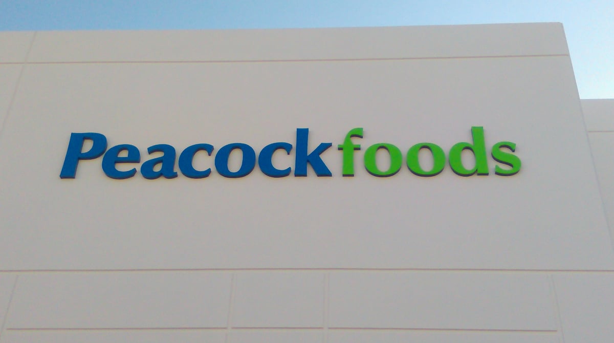 White flat-cut dimensional letters on commercial building facade