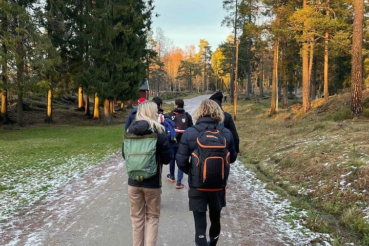 Hikers following the guide along a forest trail outside Oslo