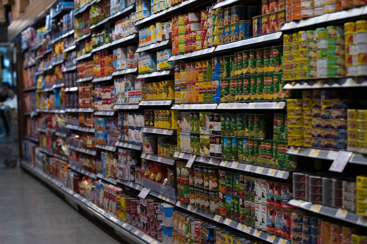 A supermarket aisle lined with shelves of canned goods