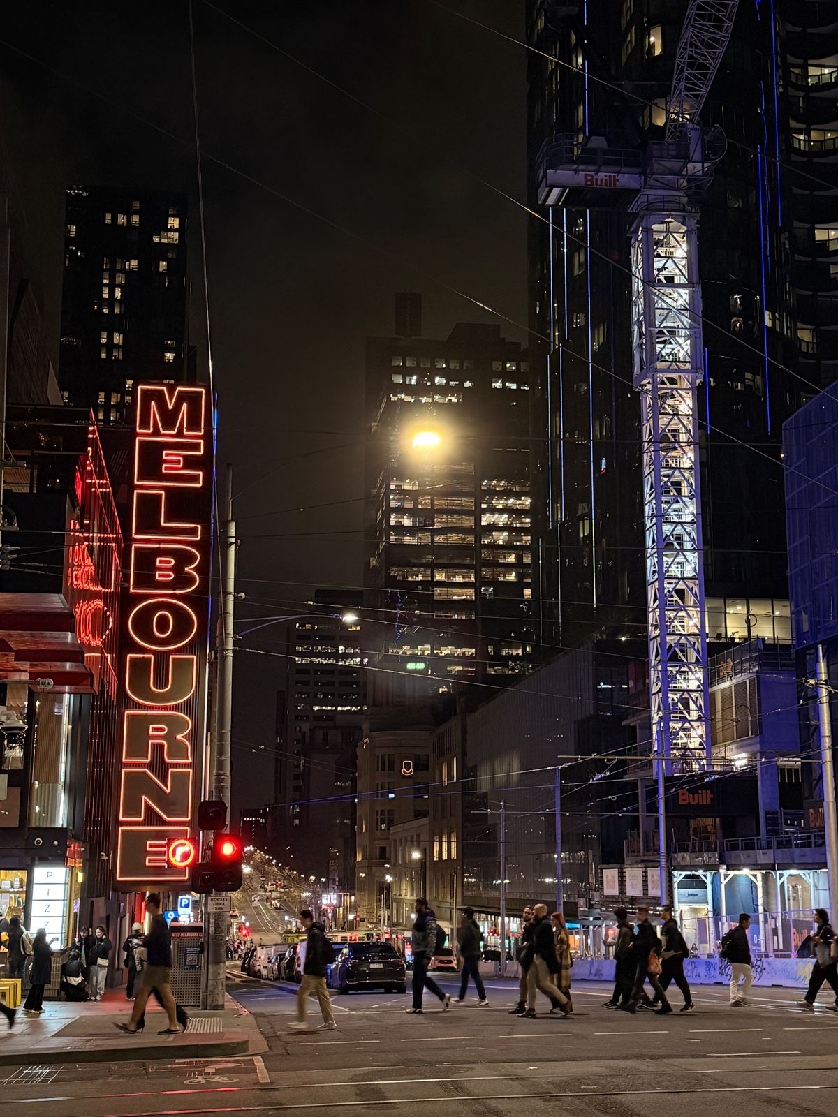The neon Melbourne sign glowing at night in the CBD