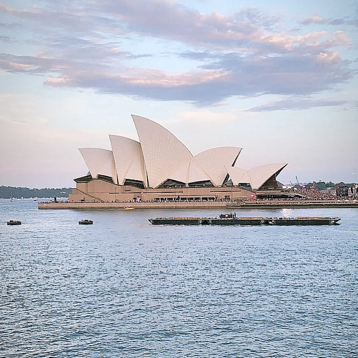 The Sydney Opera House at dusk seen across the harbour