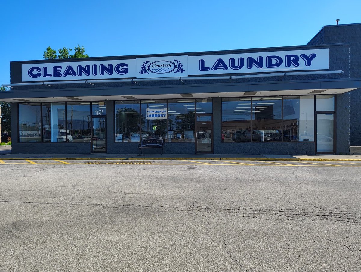 Courtesy Cleaning storefront on E Oakland Ave, Bloomington IL — commercial laundry and linen service
