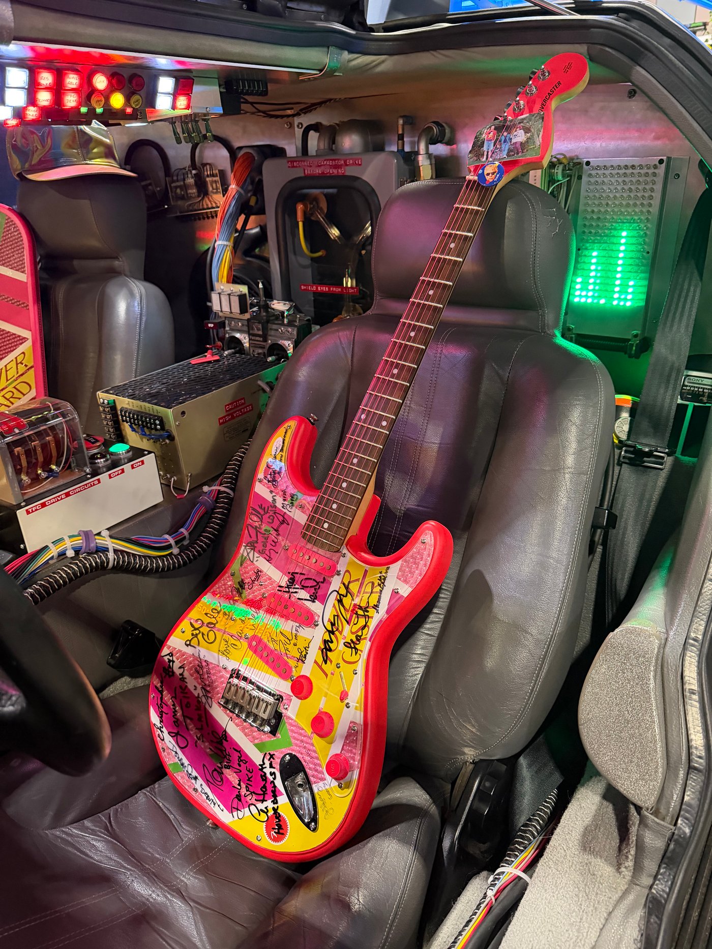 Signed guitar inside the DeLorean Time Machine cockpit at Fan Expo