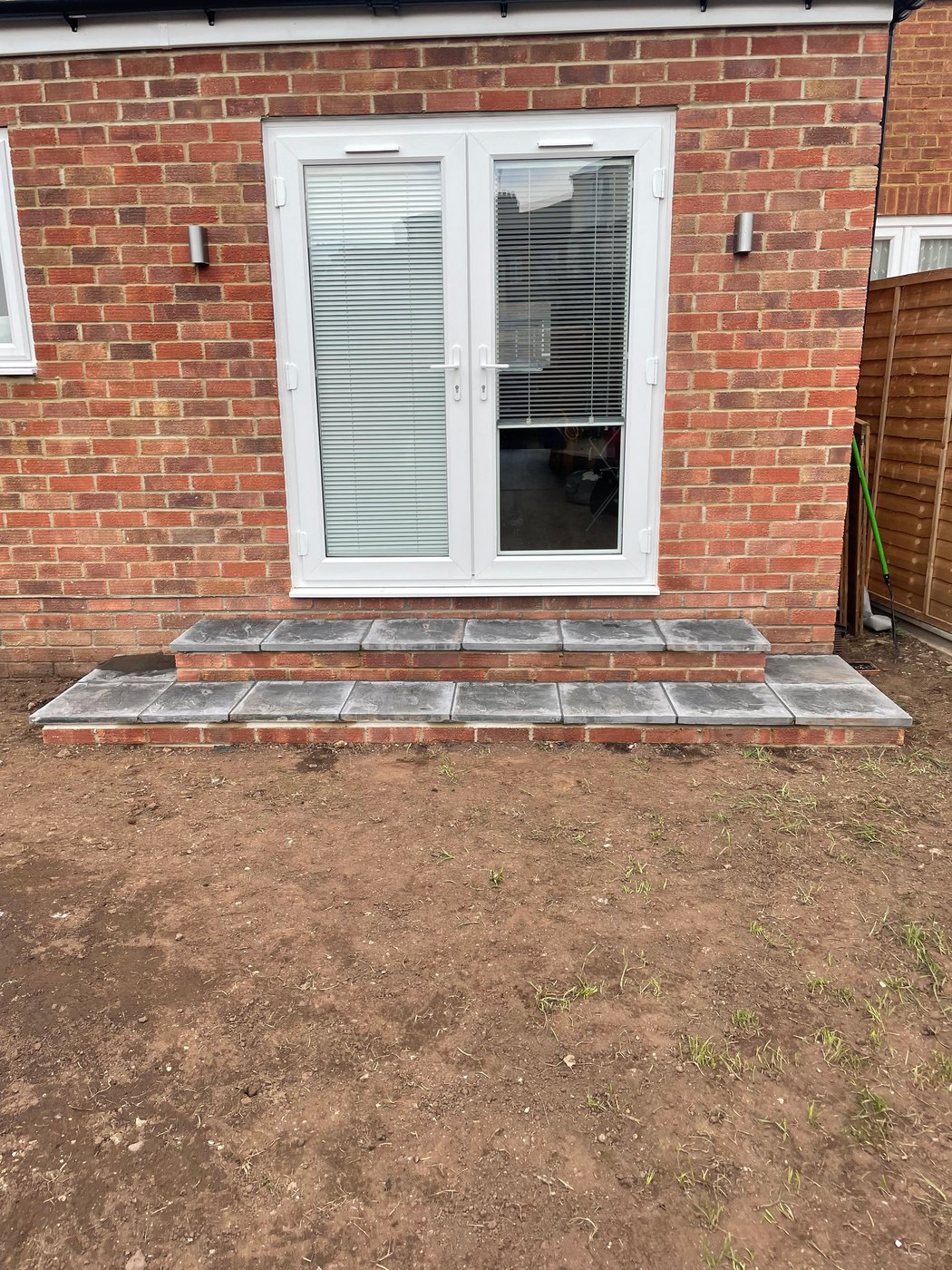 Rear extension with brick steps and slate paving