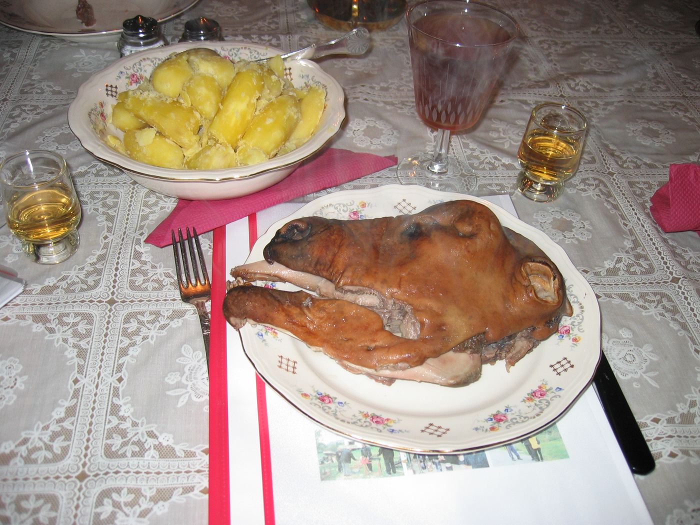 A steamed smalahove, a whole sheep's head, served on a plate with boiled potatoes