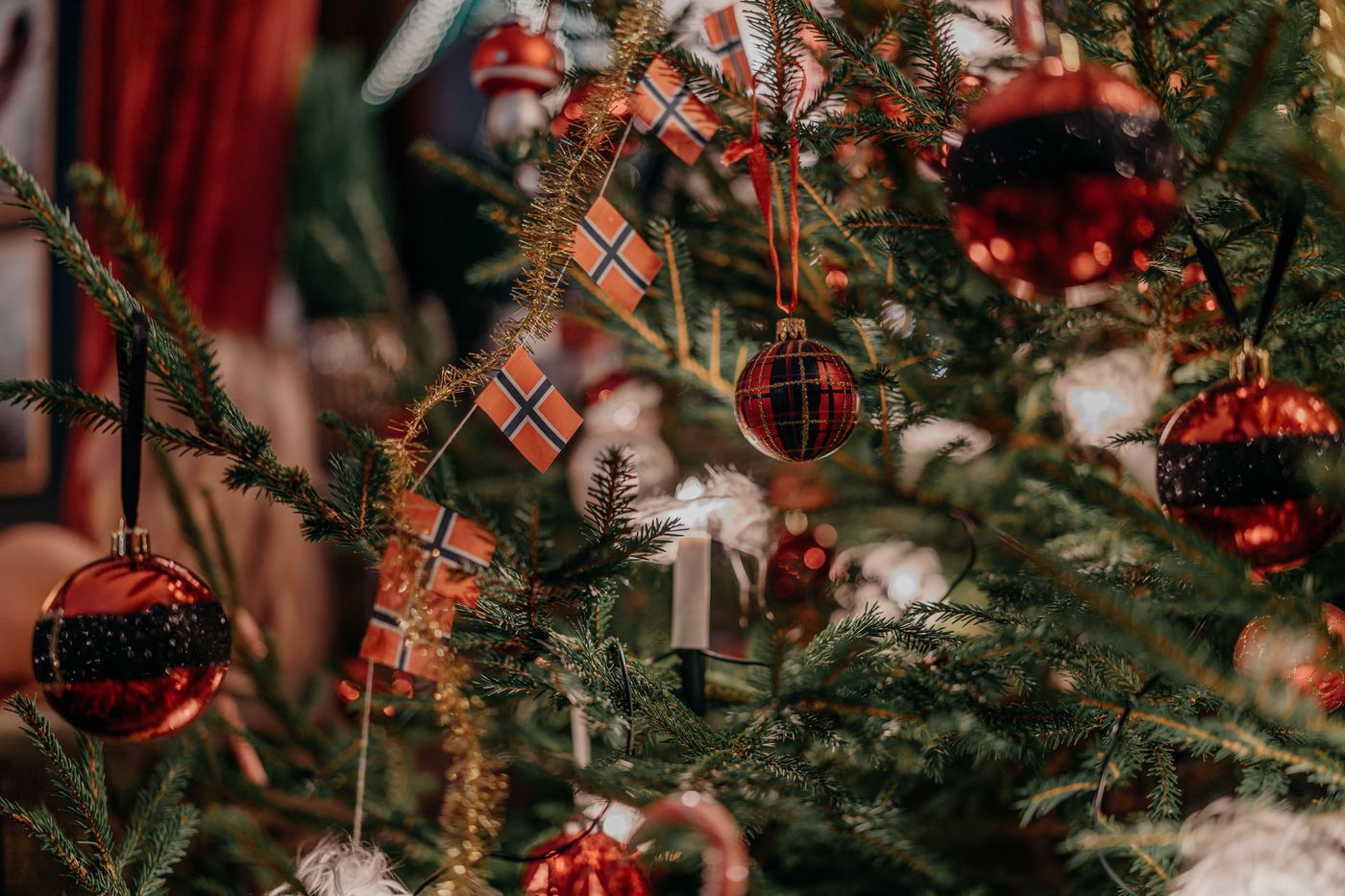 Norwegian Christmas tree decorated with small Norwegian flags and red baubles