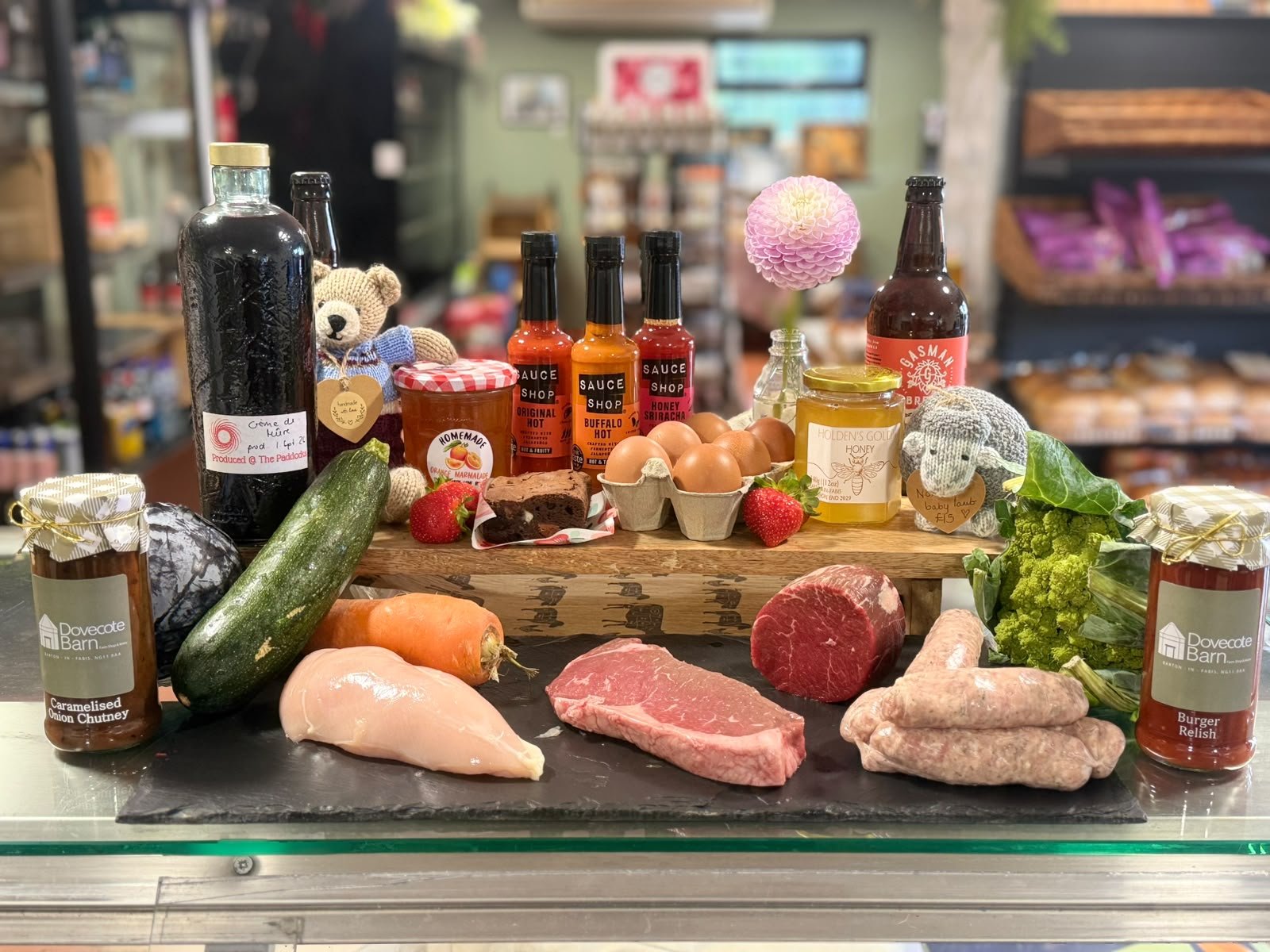 Dovecote Farm Shop produce on the counter: home-reared meat, eggs, chutneys, sauces and local honey