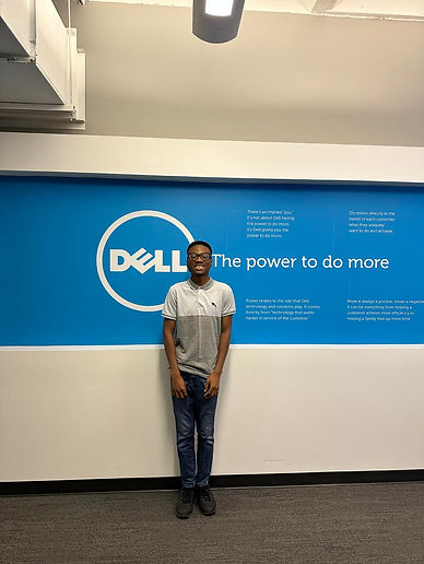Anthony Aiyedun standing in front of the Dell logo
