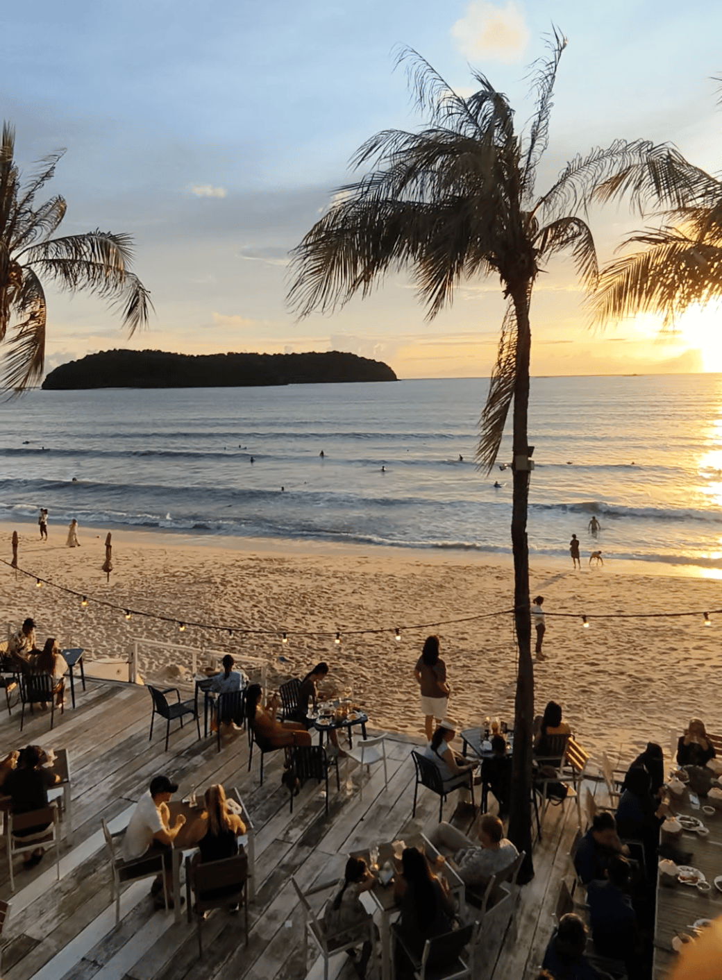 Diners on a beachfront deck at sunset in Langkawi
