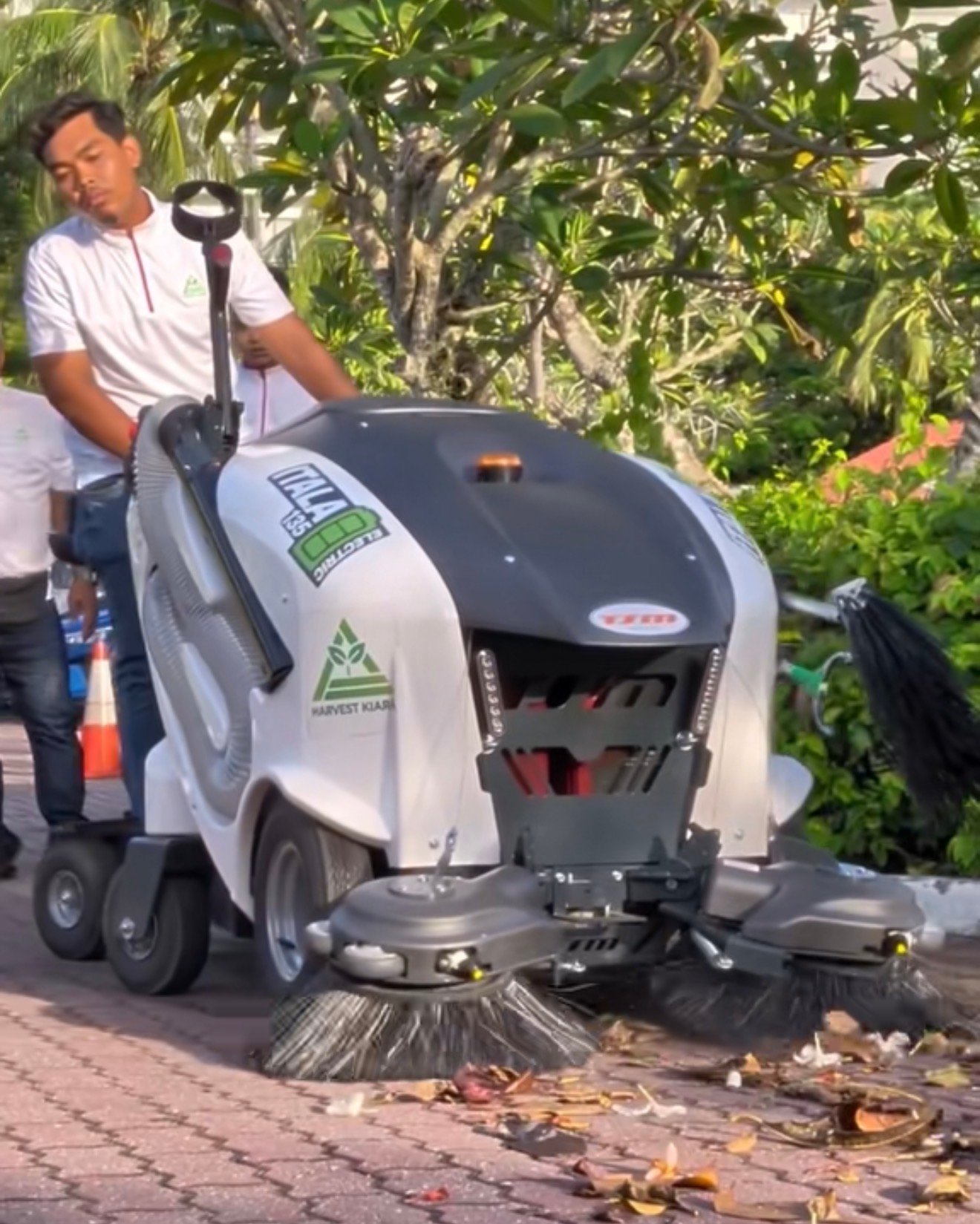 An electric road sweeper cleaning the roadside at Pantai Tengah