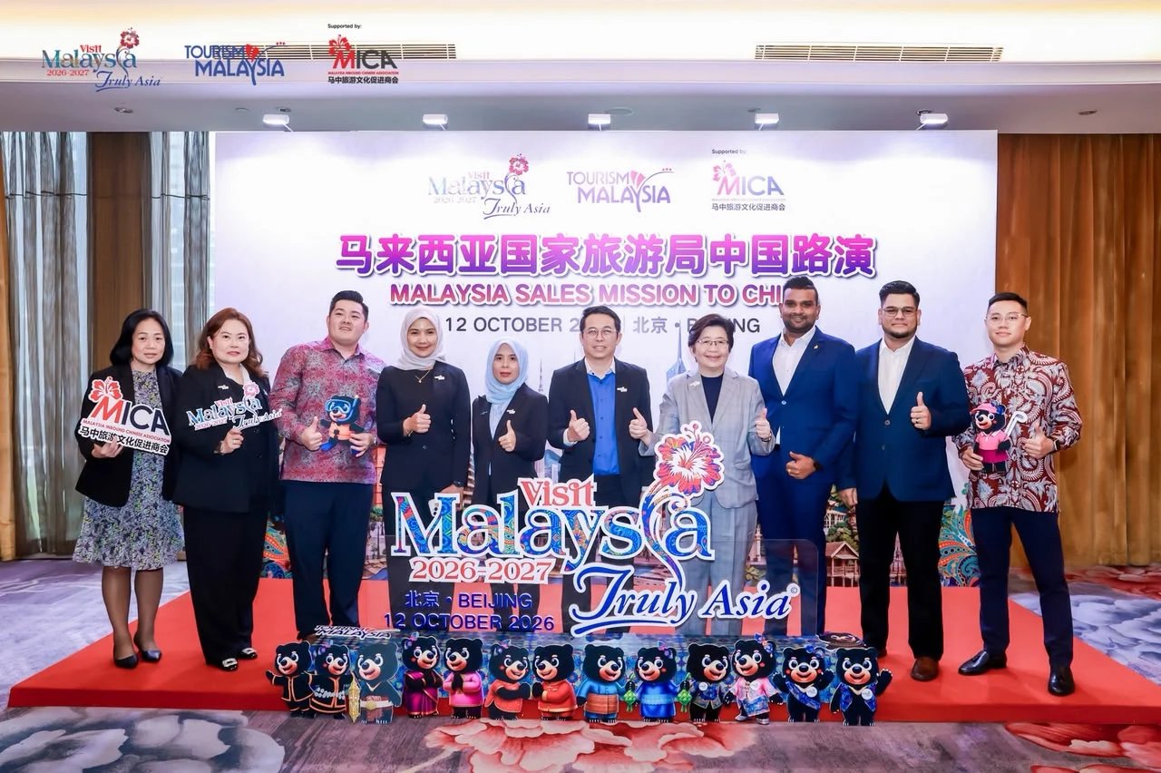 Delegates and officials posing in front of the Malaysia Sales Mission to China backdrop in Beijing on 12 October 2026