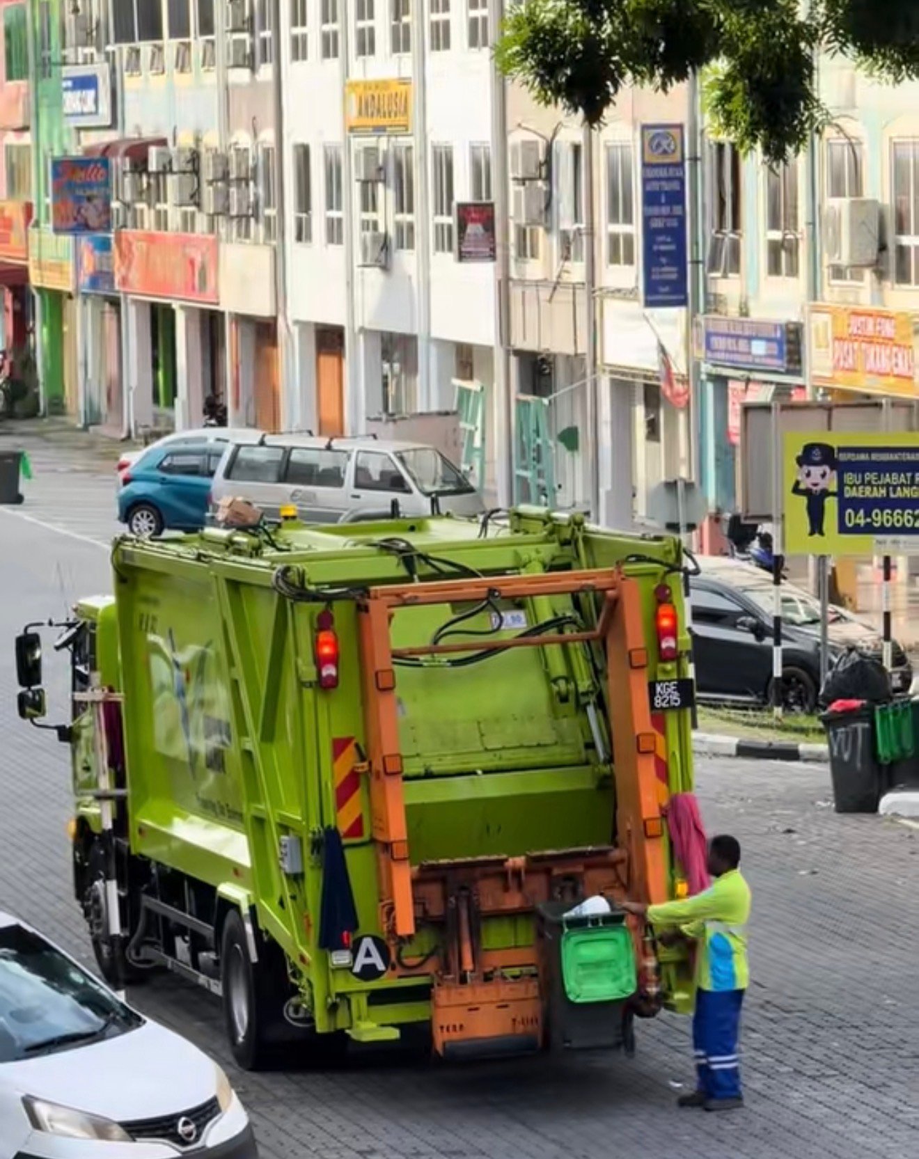 A city dump truck on its daily morning rounds in Langkawi