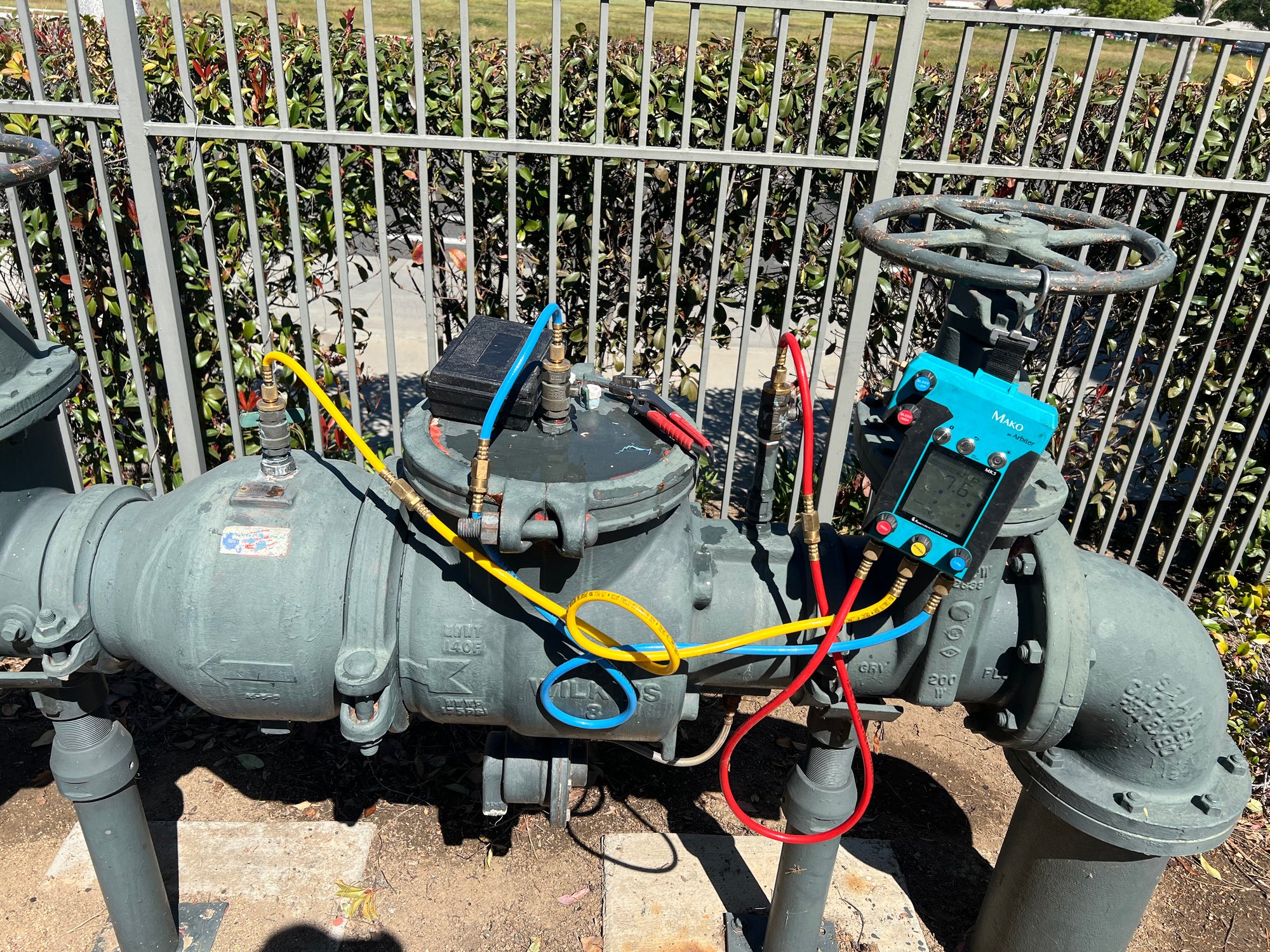 Annual compliance test being performed on backflow assembly