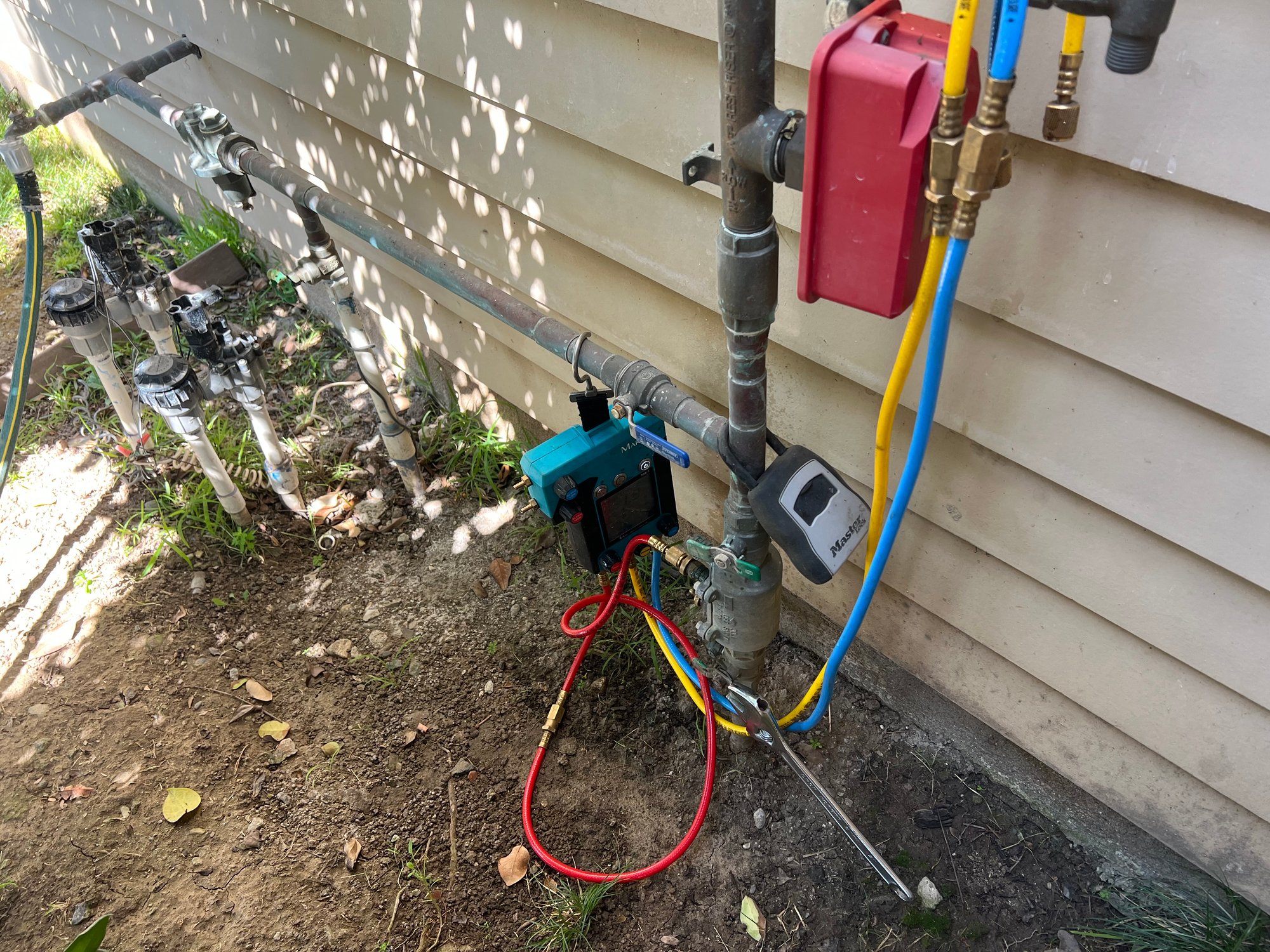 Testing small residential backflow assembly on house exterior