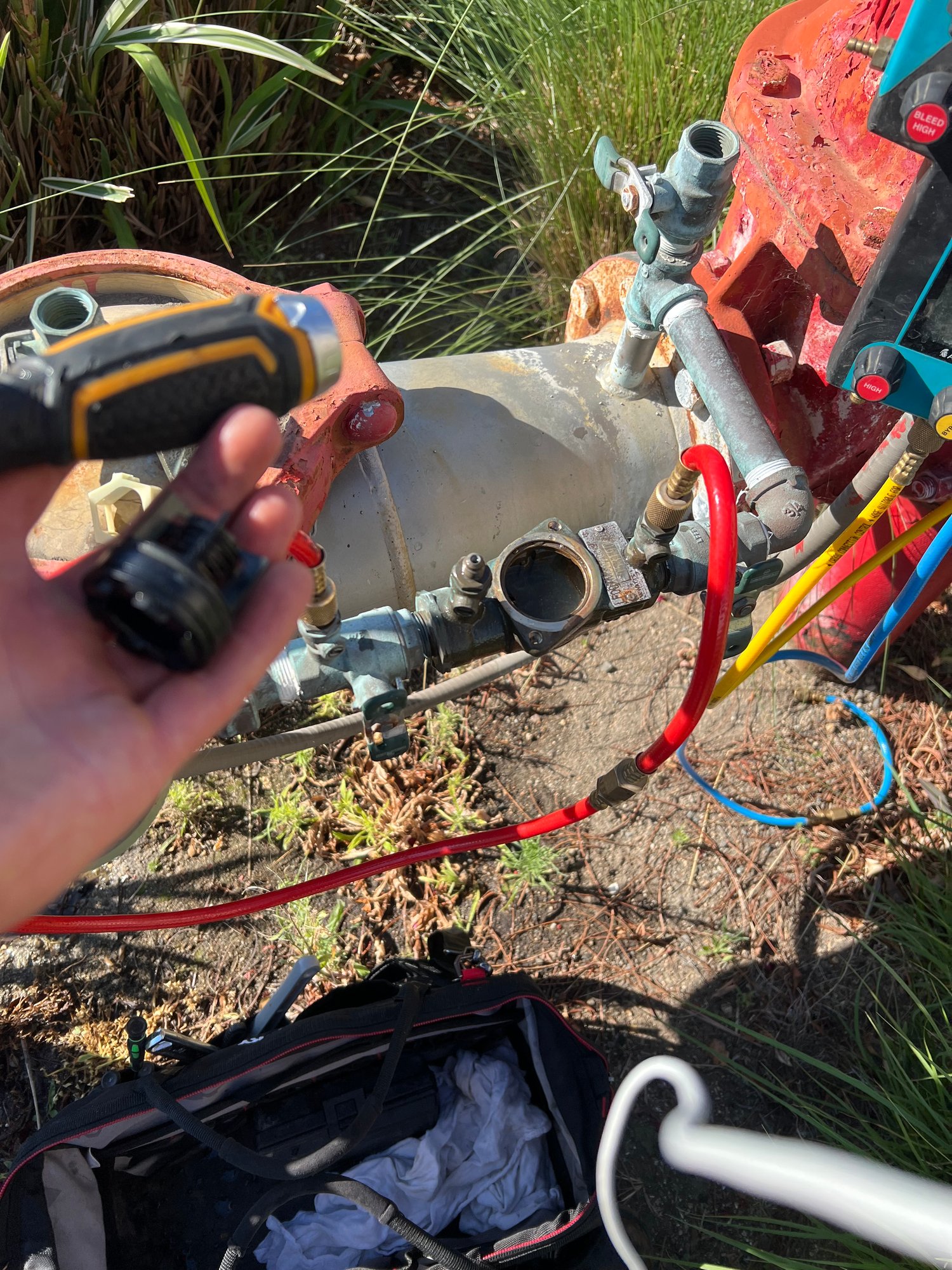 Technician using drill to service large commercial backflow assembly
