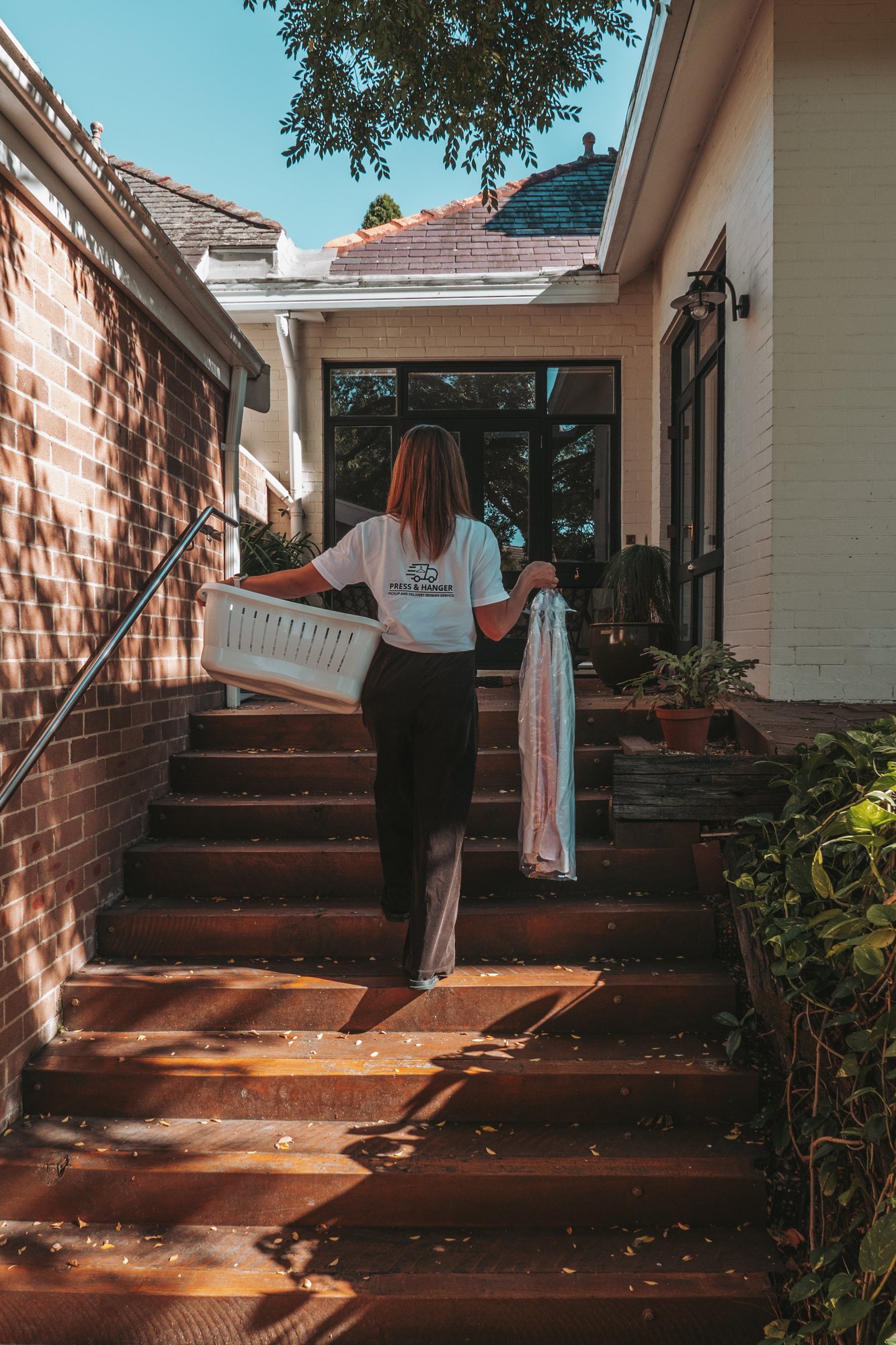 Press & Hanger staff delivering ironing to a Sydney home