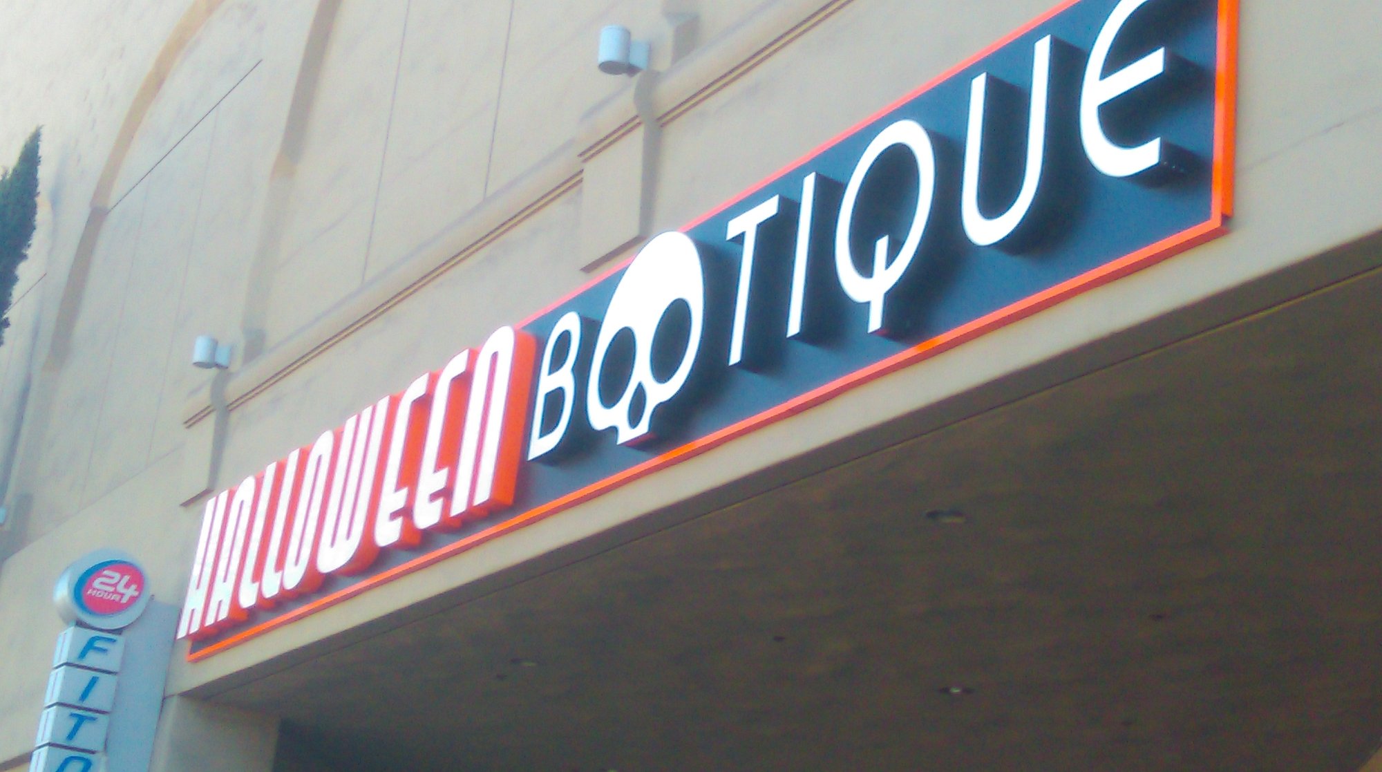Front-lit LED channel letters with illuminated orange border at night