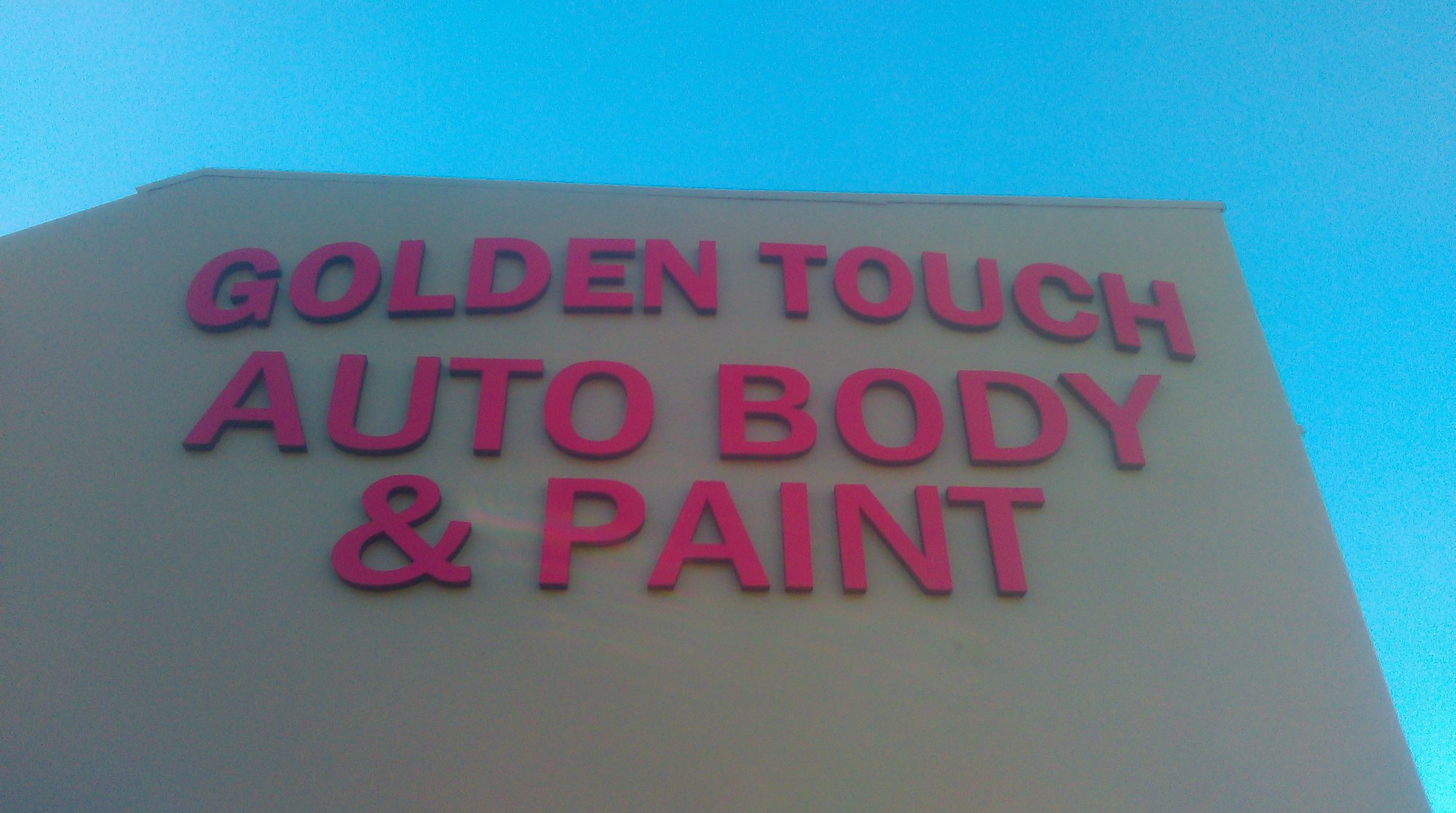 Illuminated cabinet sign installed above retail storefront entrance