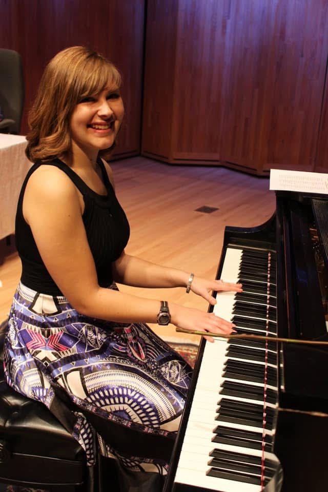 Joy playing grand piano in studio