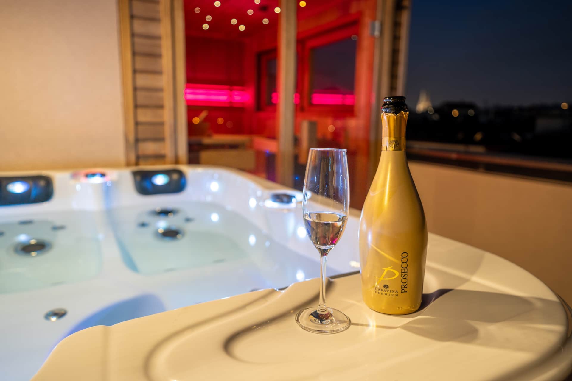 Rooftop hot tub with prosecco and sauna in background