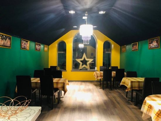 Inside Madame Mews, with bright yellow walls and a golden star above the window