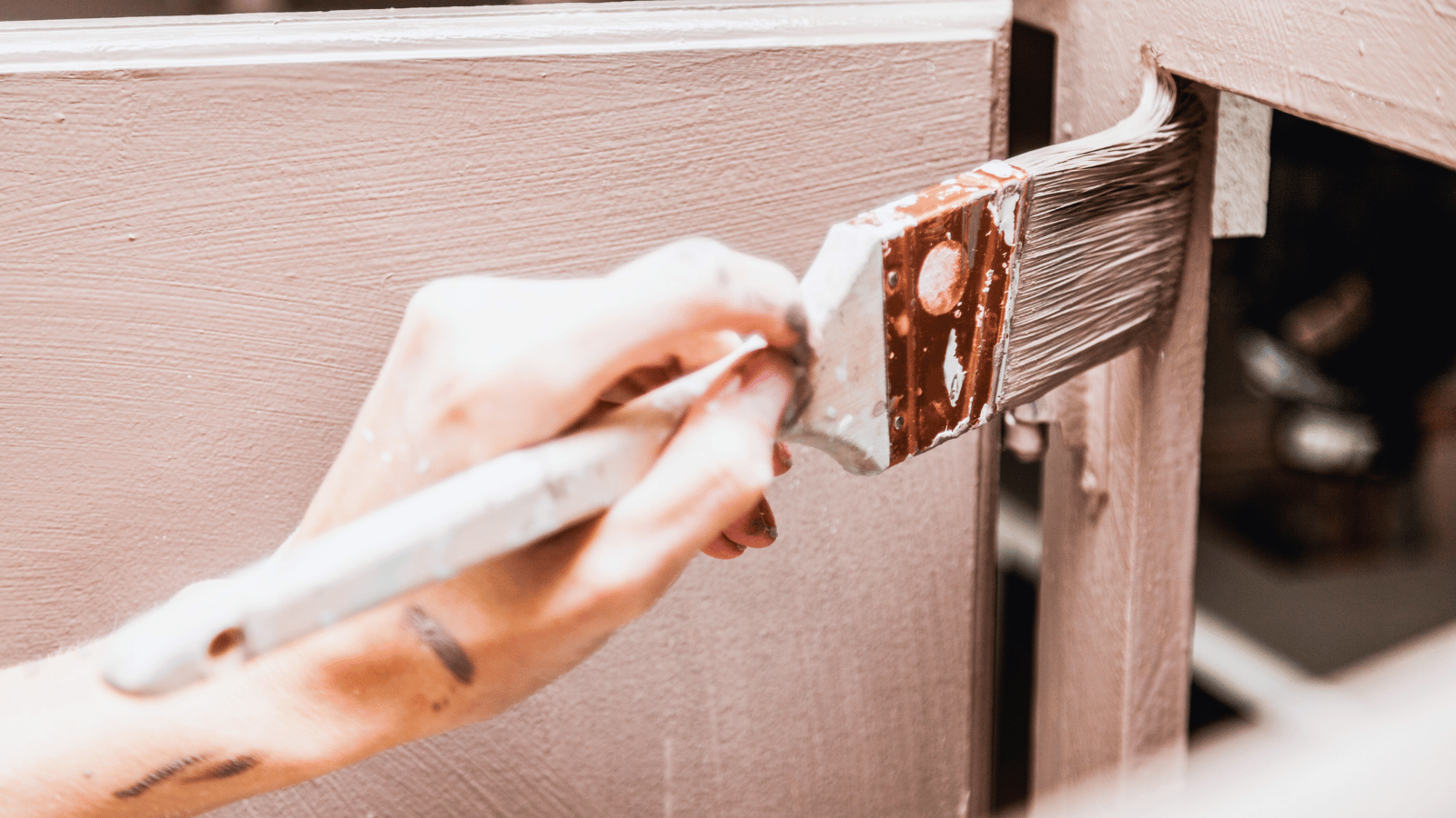 Painter working on siding
