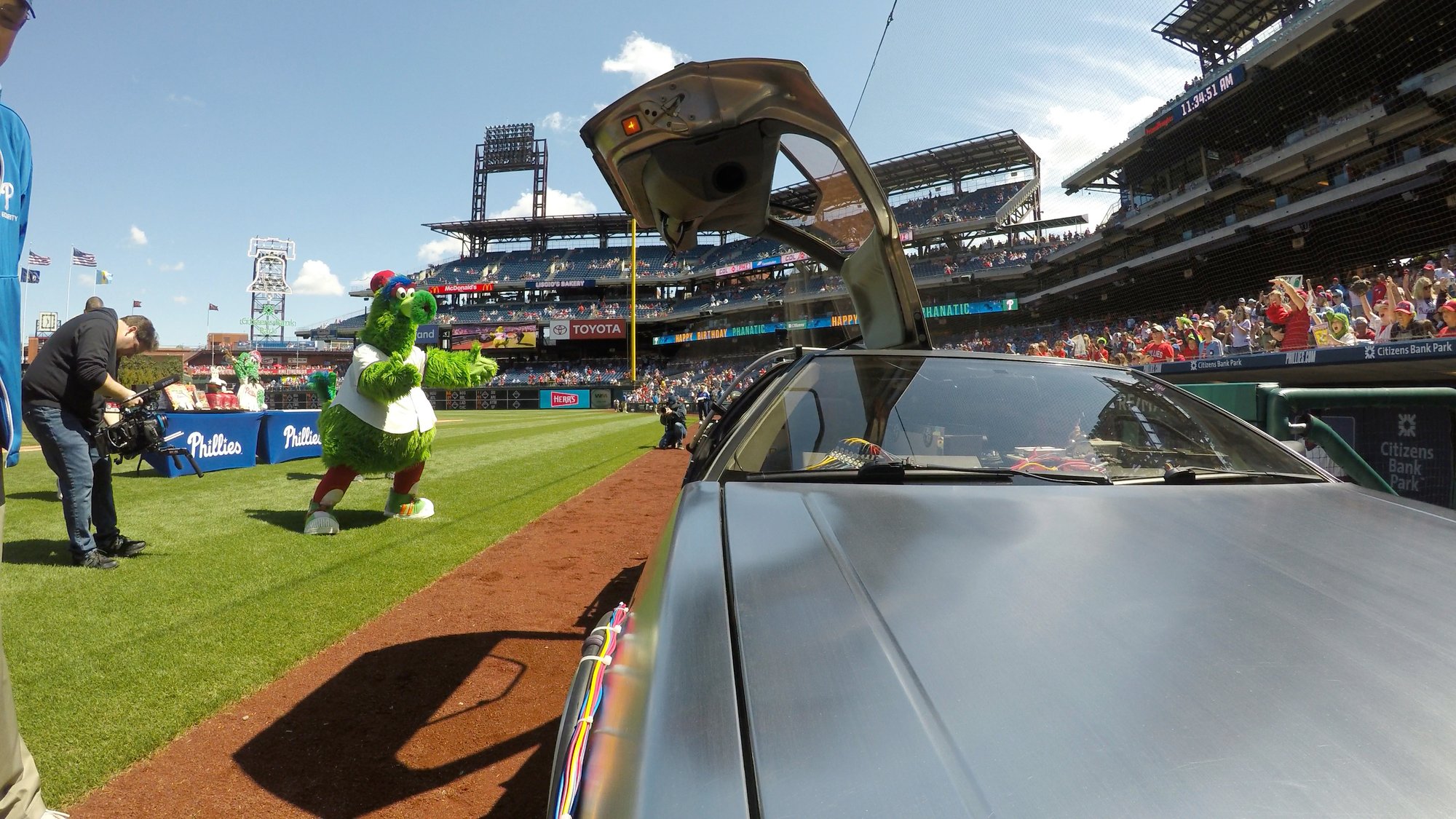 Phillie Phanatic celebrating with the DeLorean Time Machine
