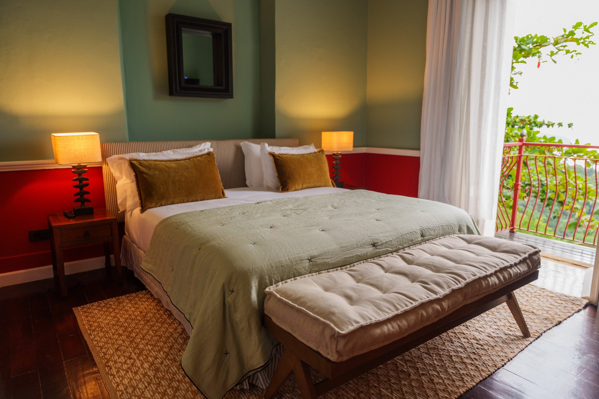 Bed and balcony in a Panoramic Suite at Belo Monte with views over the forest, bay and ocean