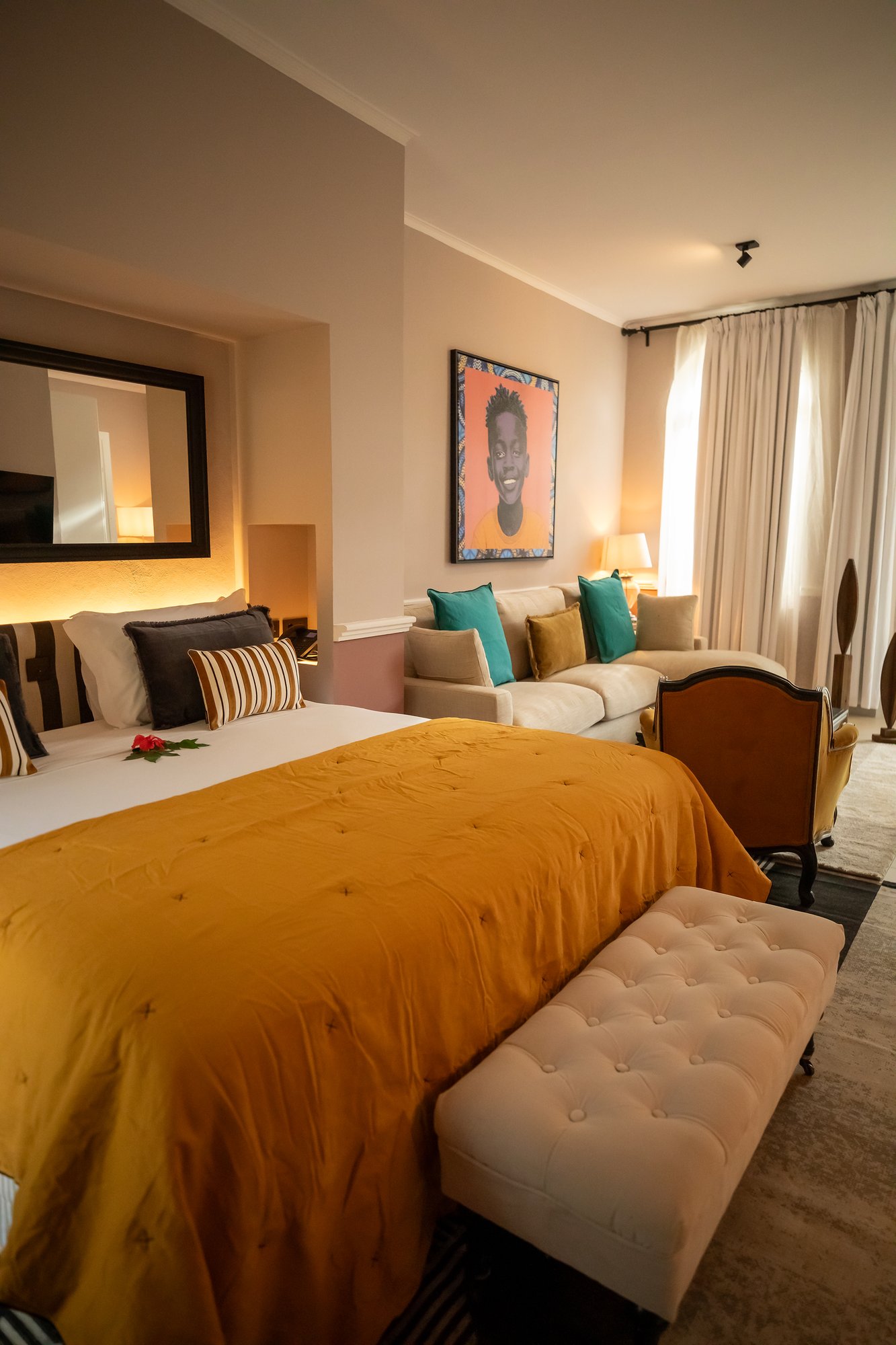 Bed and sofa inside a Suite at Belo Monte, overlooking the gardens and forest