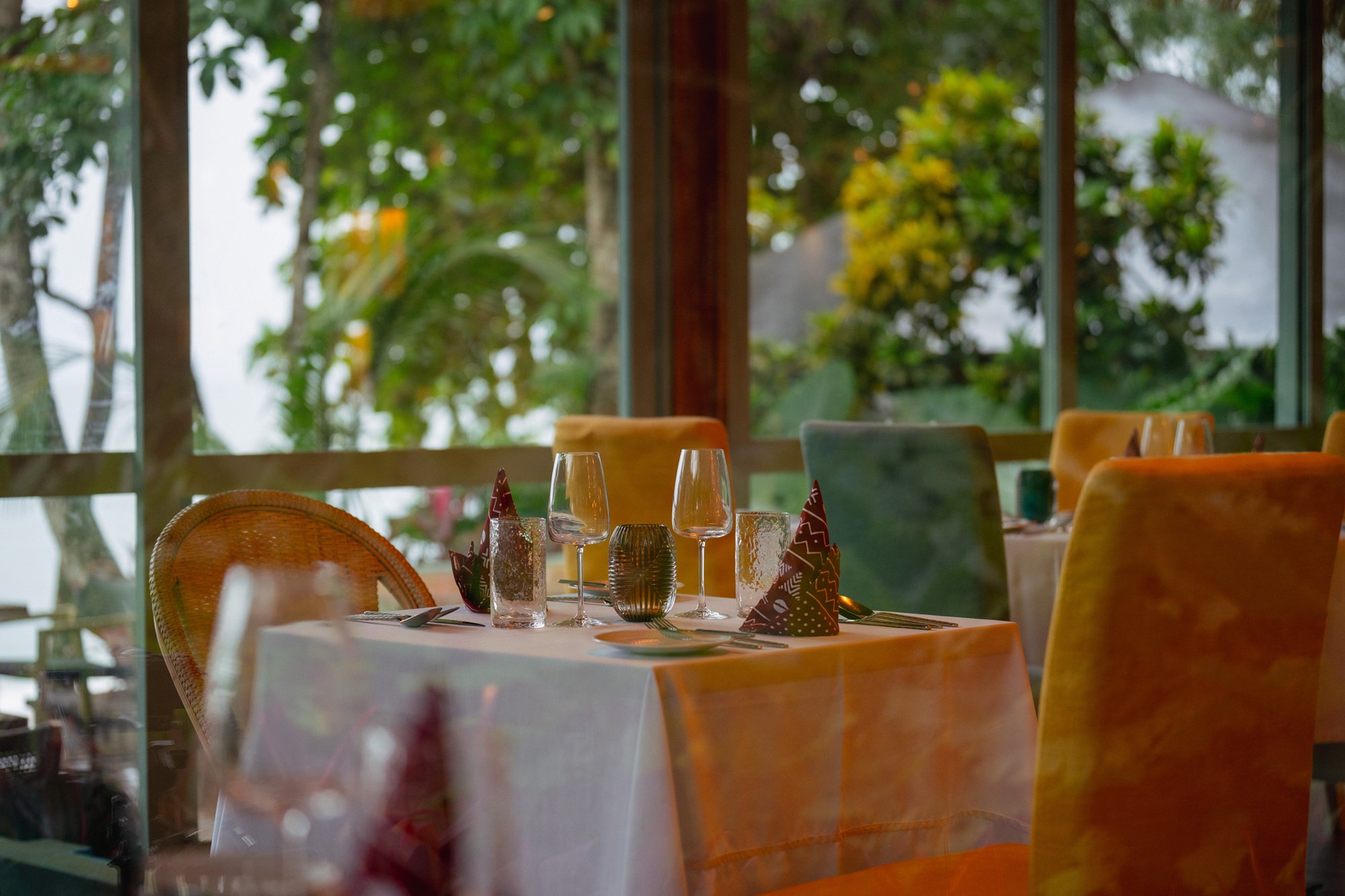 Restaurant table set for dinner at Bom Bom overlooking the gardens