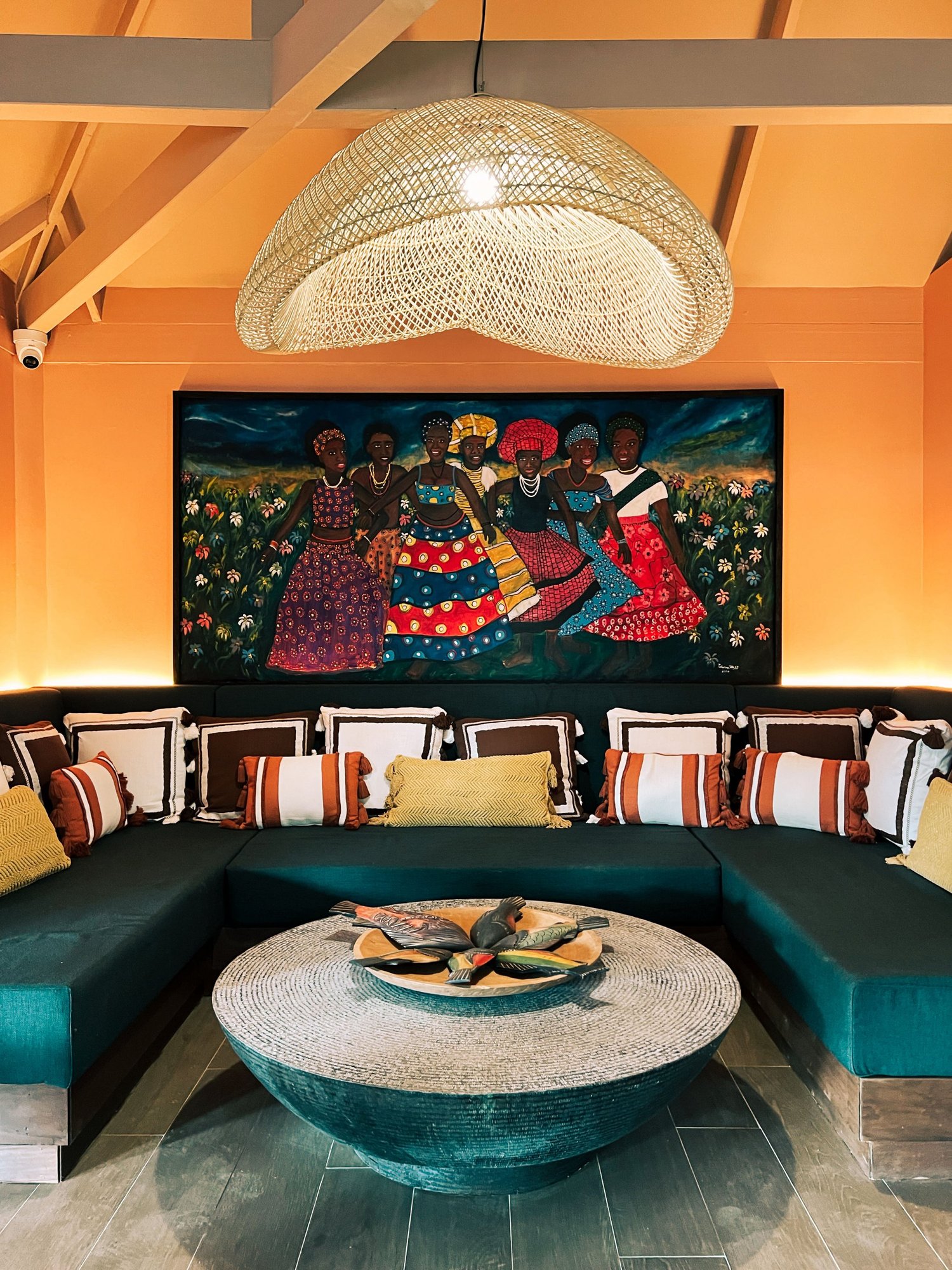 Living area inside a thatched-roof bungalow at Bom Bom with tropical furnishings